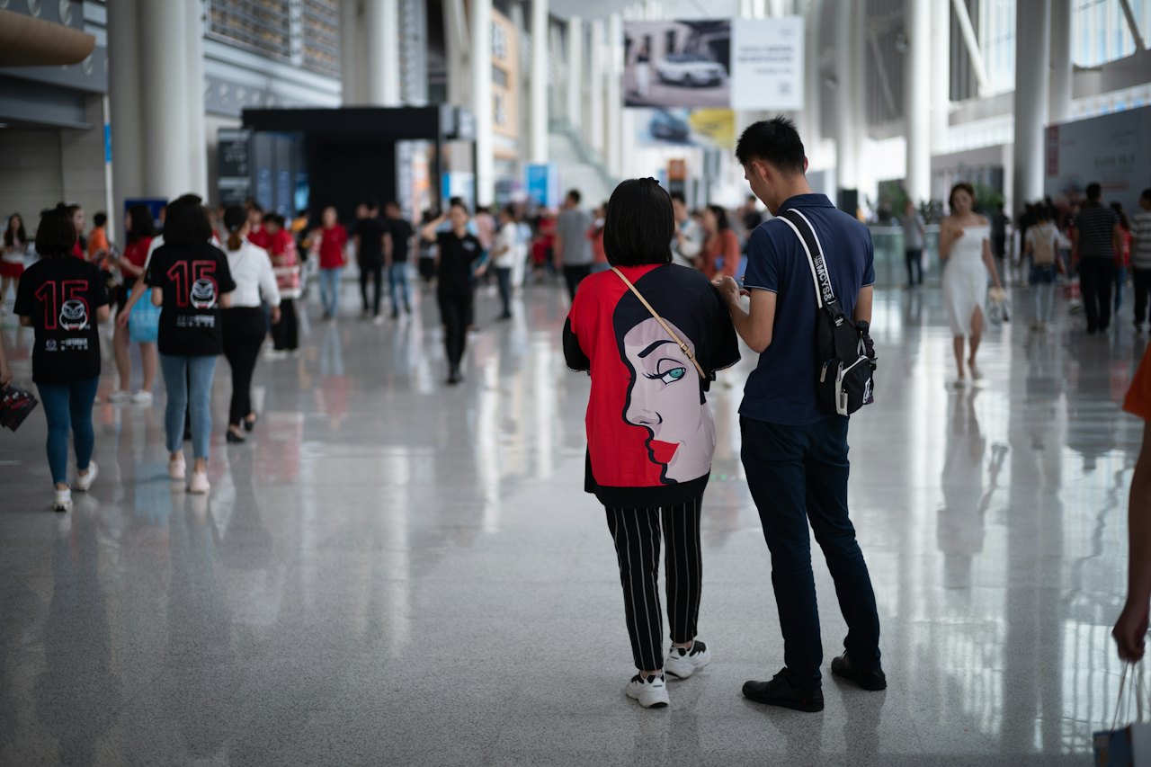 Visitors walking through a large convention centre