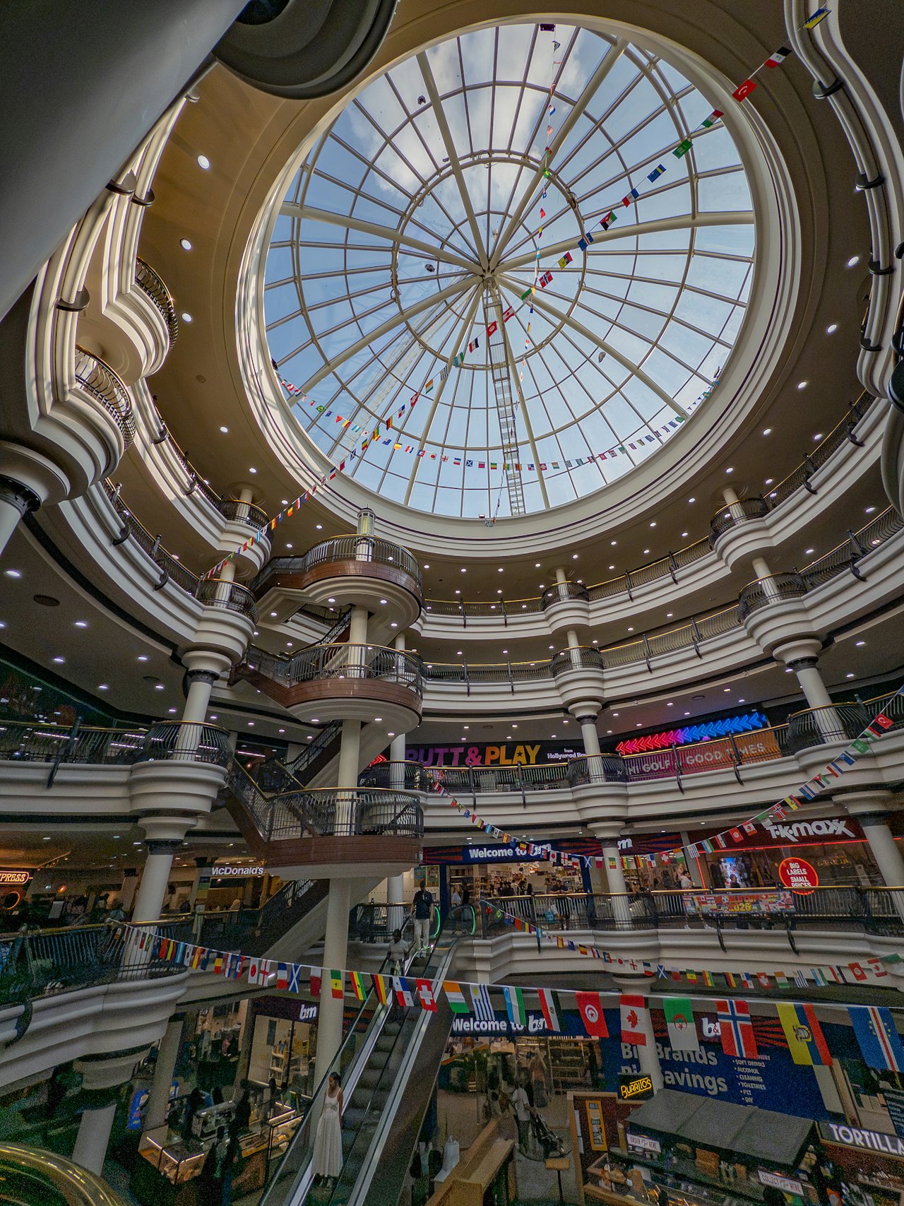 Looking up at the glass dome of a shopping mall